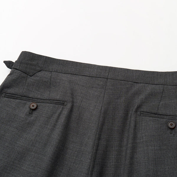 Gray suit pants with a button on a white background
