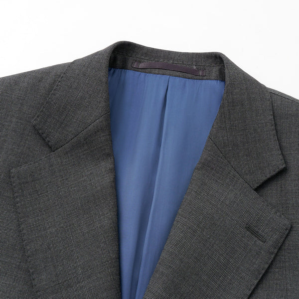 Gray suit jacket with blue lining on a white background