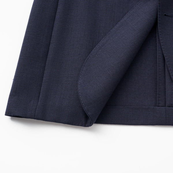 Close-up of a navy blue suit jacket on a white background
